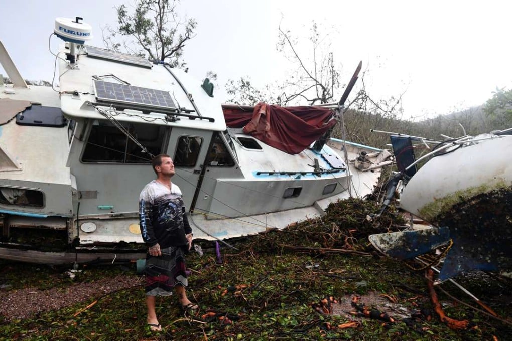 Bradley Mitchell inspects the wreckage of yachts washed ashore by Cyclone Debbie at Shute Harbour near Airlie Beach in northern Australia on Wednesday. Photo: EPA