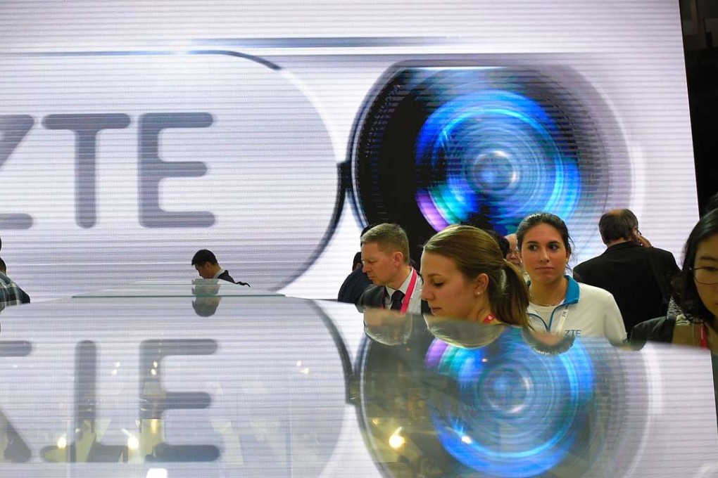 ZTE says it has been removed from the Entity List upon recommendation of the Bureau of Industry and Security. Visitors testing smart phones at ZTE's stand during the Mobile World Congress in Barcelona. Photo: AFP