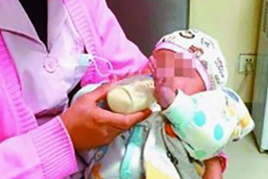 A nurse tends the abandoned child at a local hospital. Photo: Handout