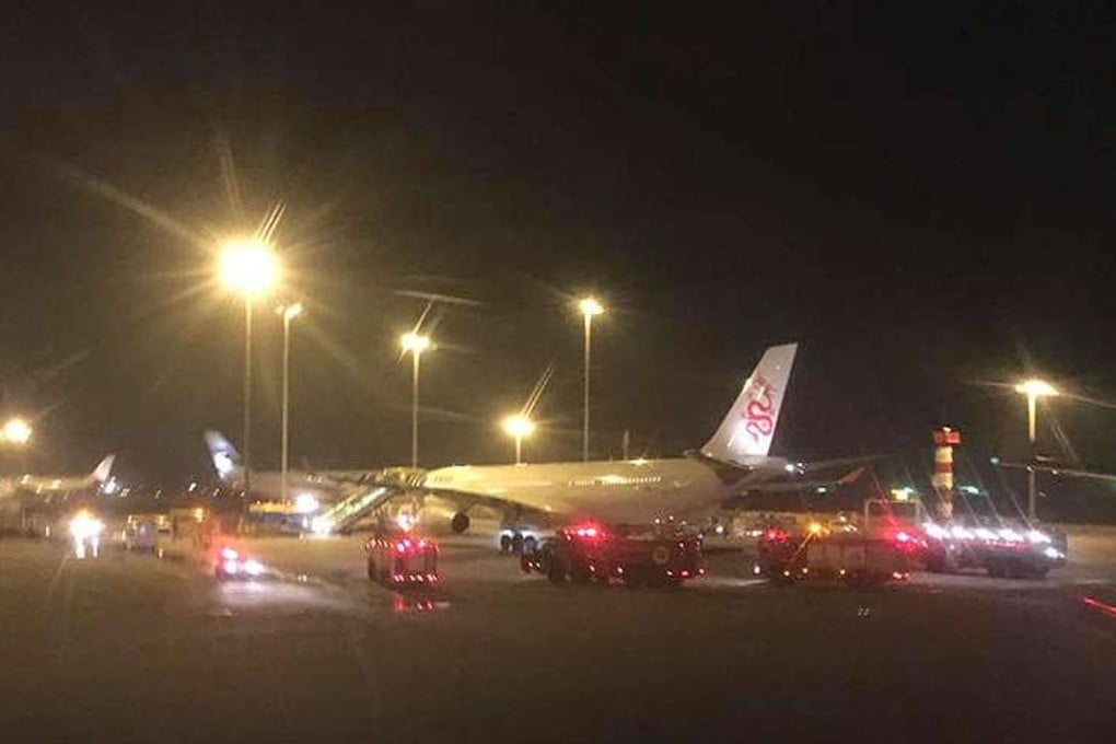 Cathay Dragon flight surrounded by emergency vehicles after an alarm issue in the rear cargo area. Photo: Facebook
