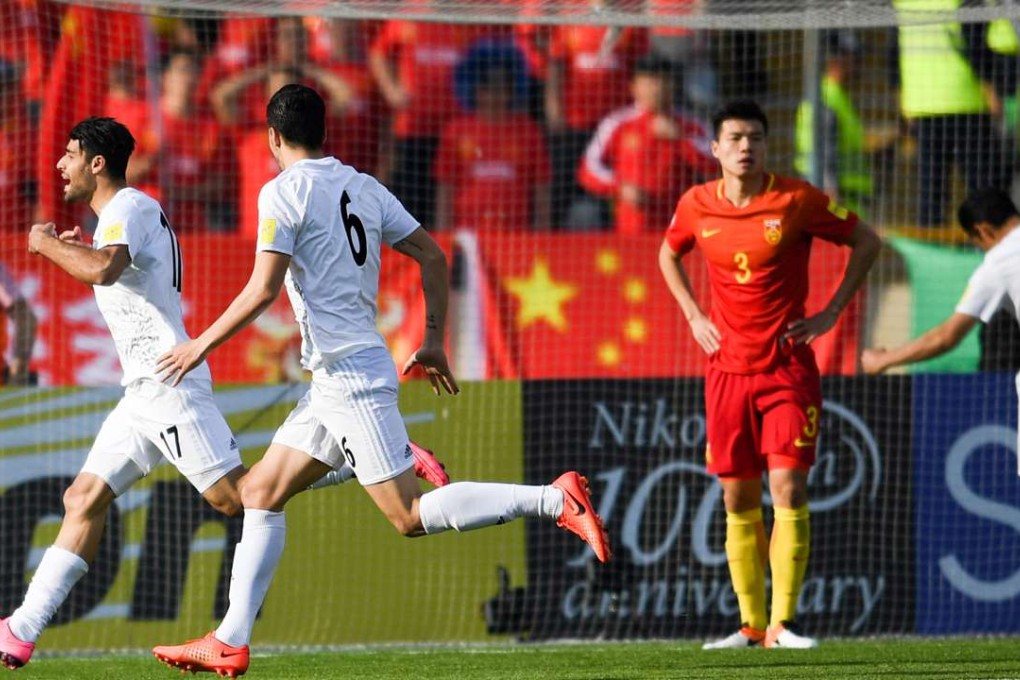 Iran's Mehdi Taremi (left) celebrates scoring against China. Photo: Xinhua