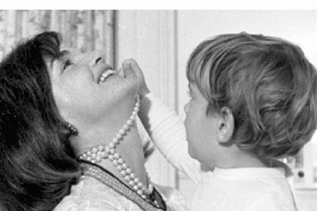 John Kennedy Jr. plays with his mother Jacqueline Kennedy's s string of false pearls in this 1962 file photo. Letters showing Jackie Kennedy turning down a British diplomat’s marriage proposal were sold at auction. Photo: Reuters