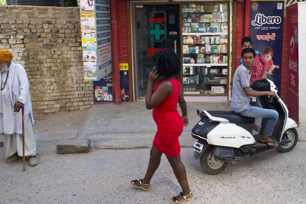 An African woman walks through one of the few New Delhi neighbourhoods where Africans can rent flats. Photo: AP