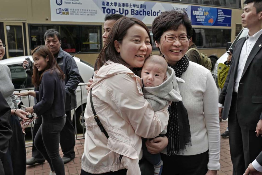 Chief executive-elect Carrie Lam takes a photo with Hong Kong residents, a day after she was elected. Probably the majority of Hong Kong people agree that we need to make progress on economic opportunities, the cost of housing, the education system or air quality. Lam will need to deliver in terms of policies that serve the interests of the broad community. Photo: AP