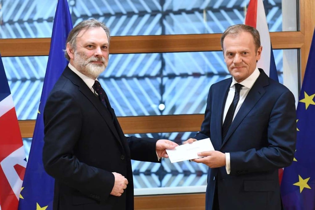 Britain's ambassador to the EU Tim Barrow delivers British Prime Minister Theresa May's formal notice of the UK's intention to leave the bloc under Article 50 of the EU's Lisbon Treaty to European Council President Donald Tusk. photo: AFP
