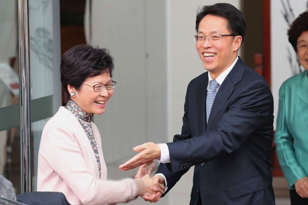 Carrie Lam is greeted by liaison office director Zhang Xiaoming. Photo: Edward Wong