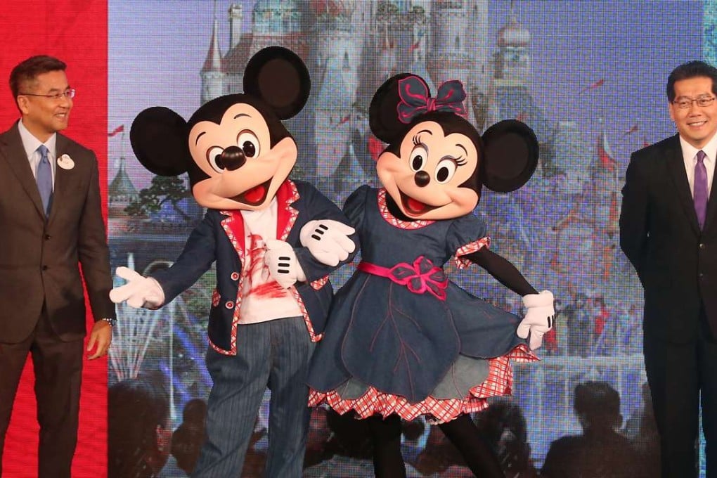 Hong Kong Disneyland managing director Samuel Lau Wing-kee (left) and commerce minister Greg So Kam-leung flanking two of the company’s most famous characters. Photo: David Wong