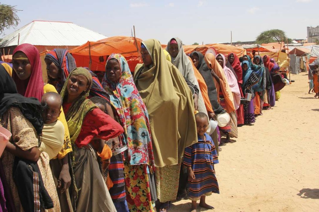 Displaced Somali women queue for food handouts in a camp outside Mogadishu, the capital of Somalia, on March, 27. Somalia's drought is threatening 3 million lives, the UN says, and aid agencies are calling for more urgent support to prevent the crisis from worsening. Photo: AP