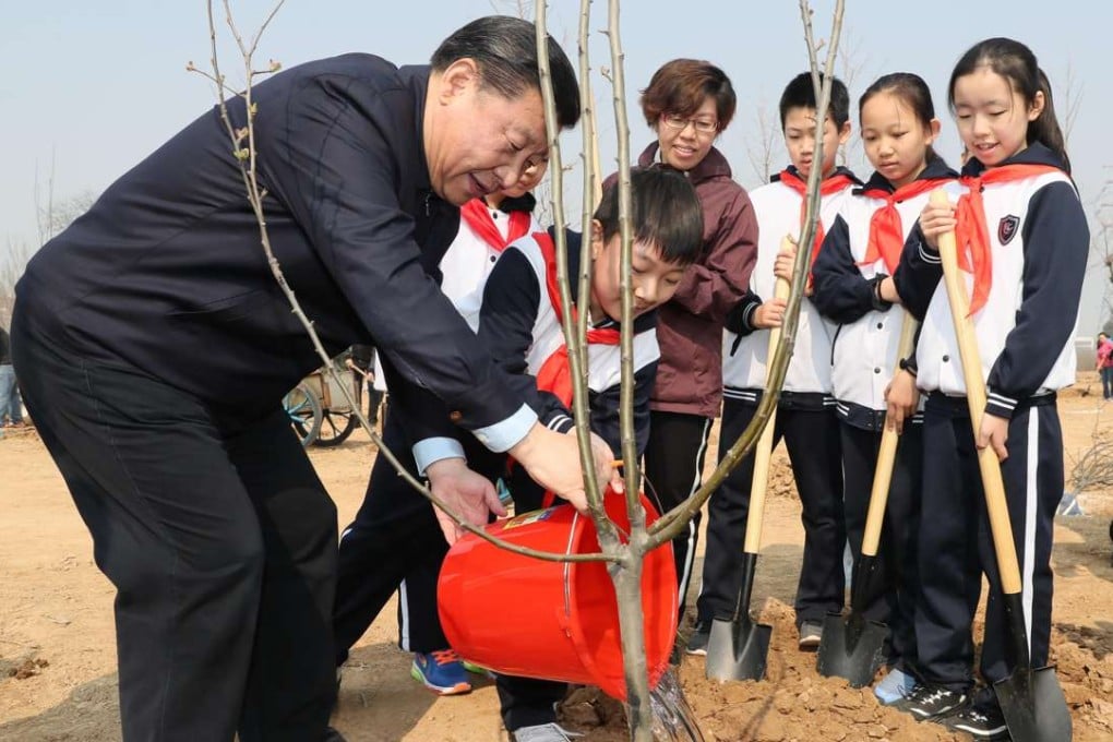 Chinese President Xi Jinping helps children water a sapling as he attends a tree-planting activity in Beijing. The leader has two major events in the coming weeks that are likely to raise China’s profile on the global stage. Photo: Xinhua