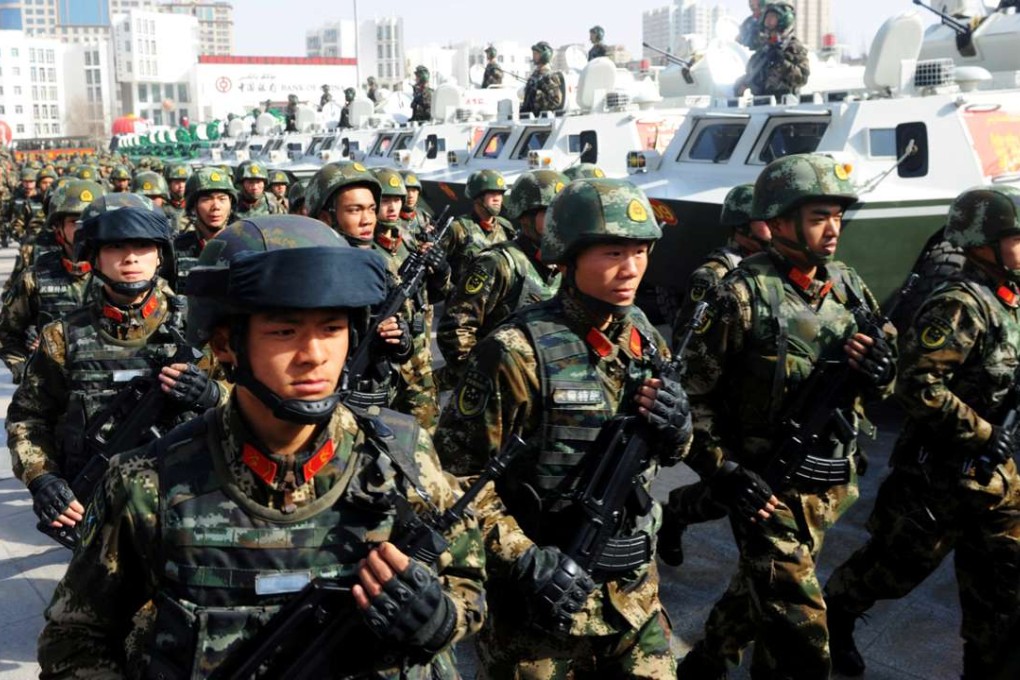 Paramilitary policemen stand in formation as they take part in an anti-terrorism oath-taking rally, in Kashgar in February. Photo: Reuters