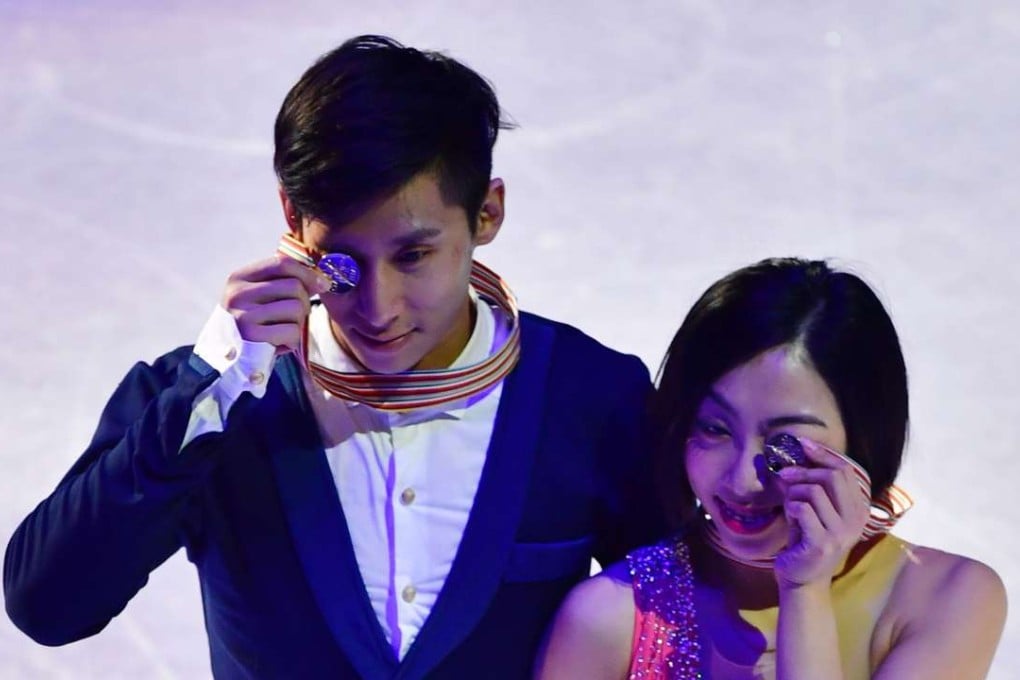 China’s Sui Wenjing and Han Cong celebrate winning the pairs free skating event at the World Figure Skating Championships in Helsinki. Photo: AFP