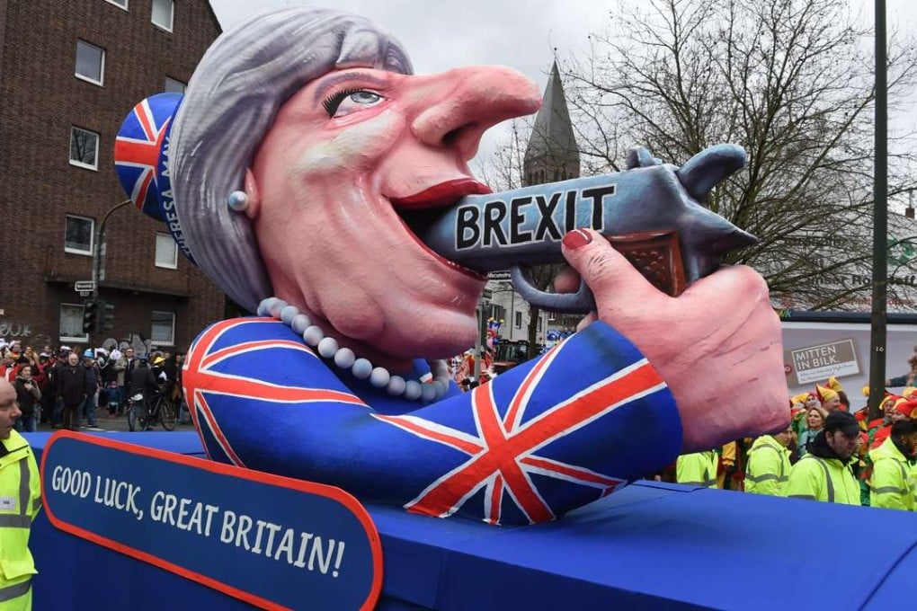 A carnival float depicting British Prime Minister Theresa May pointing a gun to her own head. Photo: AFP
