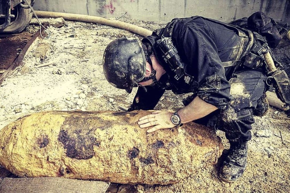 Bomb-disposal officer Adam Roberts inspects a 220kg bomb found in Pok Fu Lam on January 23. Picture: courtesy of the Police Public Relations Branch