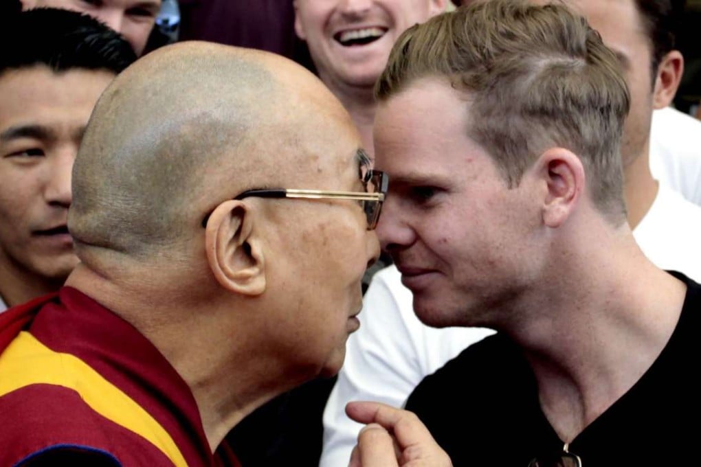 Tibetan spiritual leader the Dalai Lama and Australian cricket team captain Steven Smith rub their noses during an interaction with the team at the Tsuglakhang temple in Dharamsala, India. Photo: Getty