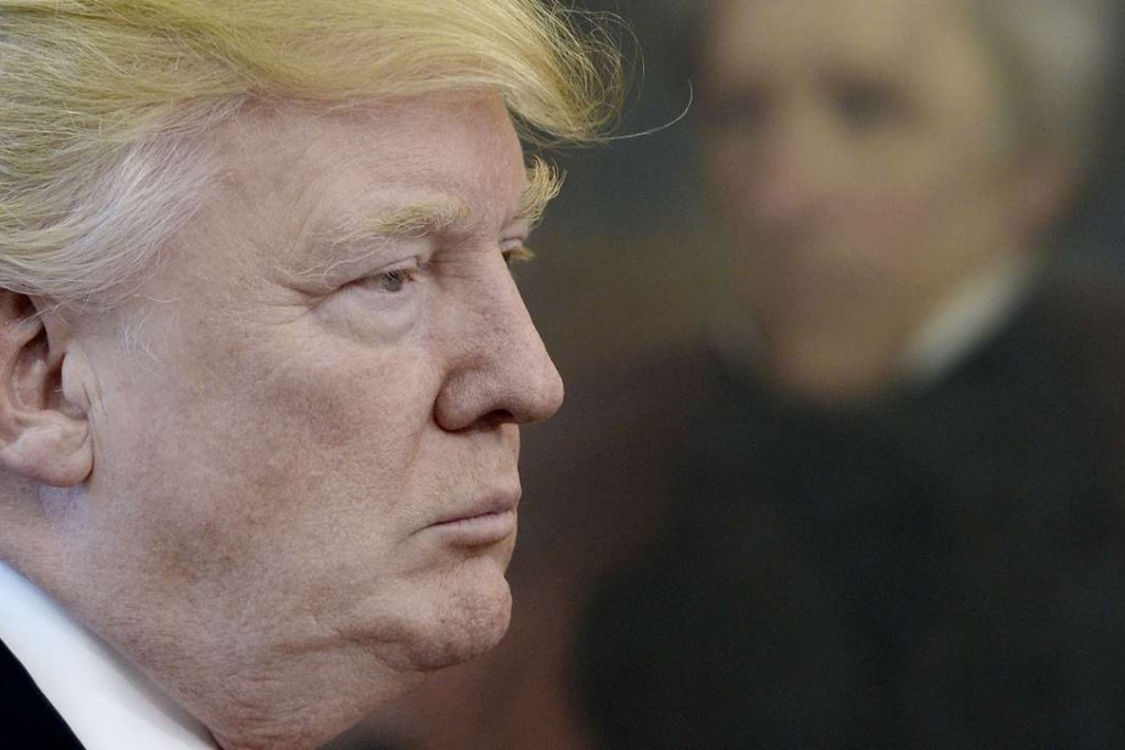US President Donald Trump listens before signing an executive order regarding trade in the Oval Office of the White House in Washington, DC. Trump ordered on Friday a comprehensive study to identify every form of "trade abuse" that contributes to US deficits with foreign countries. Photo: Pool via Bloomberg