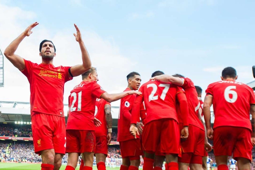 Liverpool’s Emre Can (left) and his teammates celebrate the team’s third goal against Everton. Photo: EPA