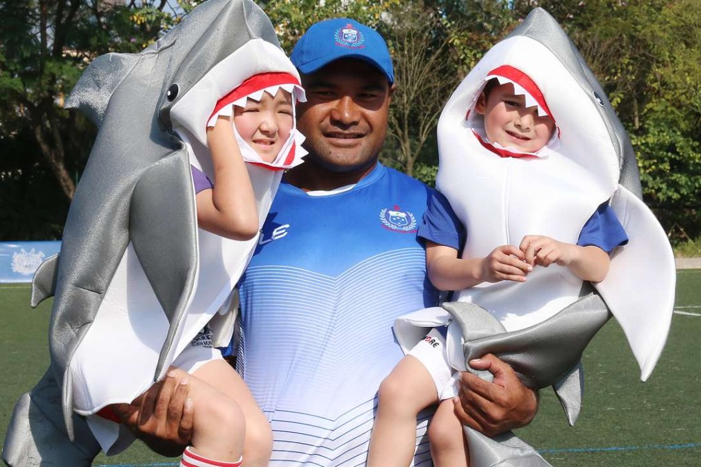 Captain Faalemiga Selesele of Samoa and kids of Tuen Mun Sharks mini rugby club dress up as sharks to raise awareness of shark conservation. Photo: K. Y. Cheng