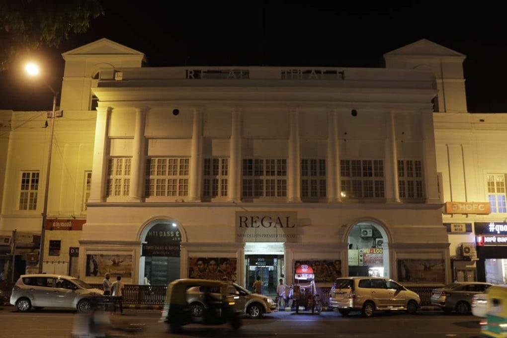Motorists drive past the colonial era Regal Theatre in New Delhi, India. Photo: AP