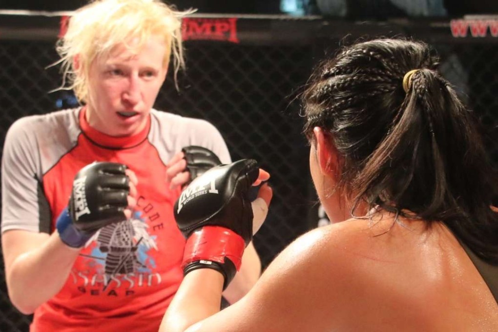 Jennifer Norris and Ramona Pascual square up during their fight at Southorn Stadium. Photo: Matthew Eaton