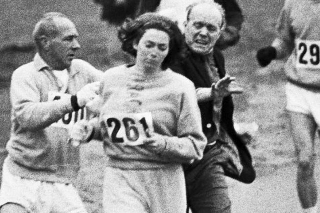 Boston Marathon race director Jock Semple tries to stop Kathrine Switzer competing in the race in 1967. To mark 50 years since that day, Switzer will run in the race this month. Photo: AP