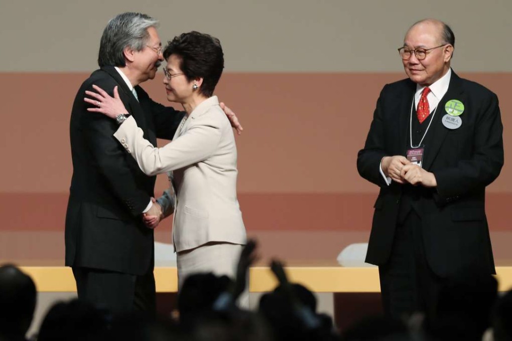 Chief executive election candidates John Tsang Chun-wah (left) and Carrie Lam Yuet-ngor (centre) embrace as fellow candidate Woo Kwok-hing looks on during the announcement of the results. Photo: Robert Ng