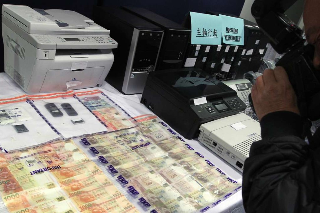 Police displays cash and equipment confiscated from a loan shark syndicate in December 2013. Photo: SCMP