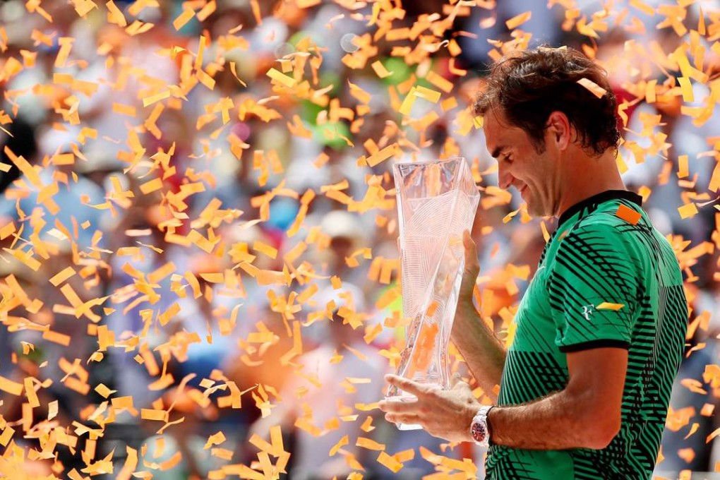 Switzerland’s Roger Federer holds the winner’s trophy after defeating Rafael Nadal in the final of the Miami Open. Photo: AFP