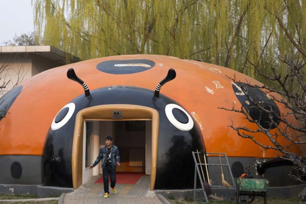 A man exits a ladybird shaped public toilet facility in Beijing on Saturday. Photo: AP