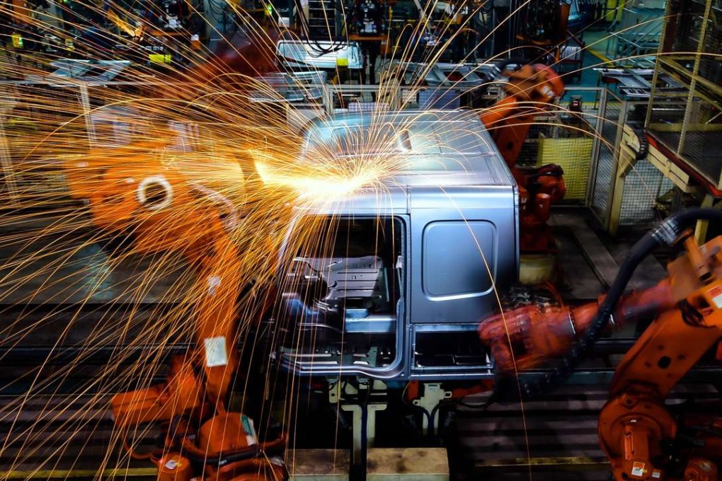 A robot welds parts at Jinan Truck Company in China's Shandong province. More than 50 per cent of annual robotics spending on the mainland is for so-called discrete manufacturing, which is the assembly-line production of distinct products like cars and smartphones. Photo: Xinhua