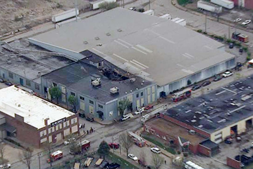 A gaping hole is seen in the roof of a St Louis box factory after an explosion sent a massive boiler soaring through the air. Photo: AP