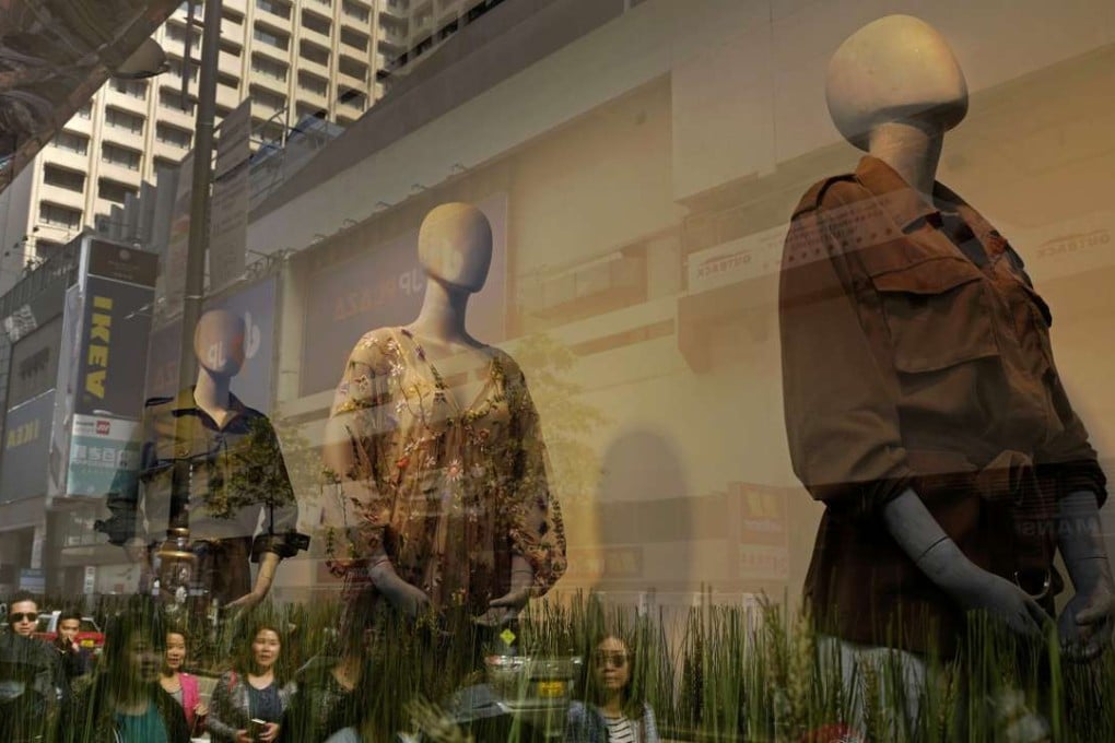 People walk past a store display in Hong Kong. It appears many Hong Kong Chinese do not respect or recognise the value of ethnic diversity. Photo: AP