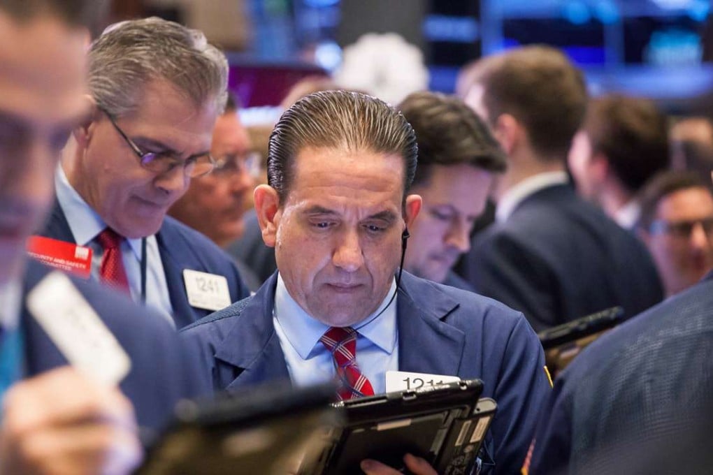 A gaggle of traders take down orders on the floor of the New York Stock Exchange (NYSE) as investors paused ahead of the summit meeting between US President Donald Trump and Chinese leader Xi Jinping. Photo: Bloomberg