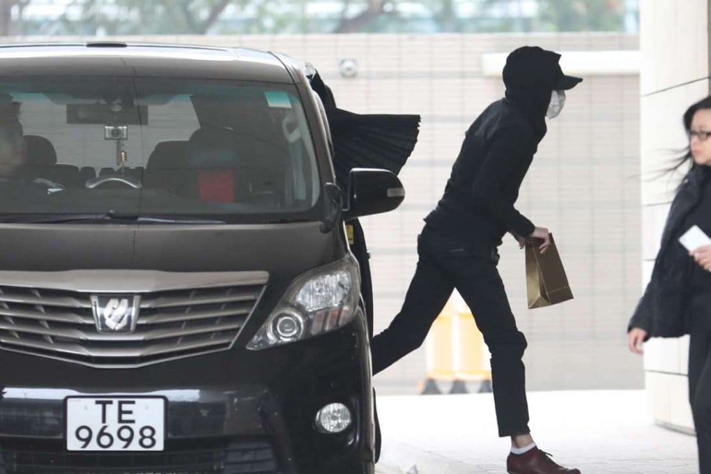 One of the five Uber Hong Kong drivers (hooded) arrives at West Kowloon Law Courts Building to stand trial at the West Kowloon Magistrates' Courts on March 10, 2017. Photo: Edward Wong