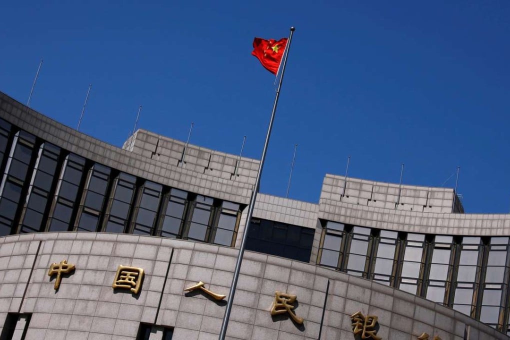 A Chinese national flag flutters outside the headquarters of the People's Bank of China in Beijing. Photo: Reuters