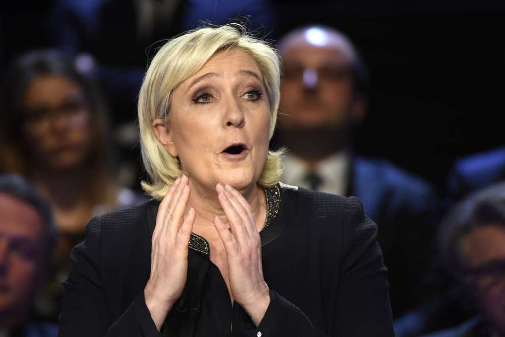 French presidential election candidate for the far-right National Front (FN) party Marine Le Pen gestures as she speaks during a debate organised by French private TV channels BFM TV and CNews on Tuesday. Photo: EPA