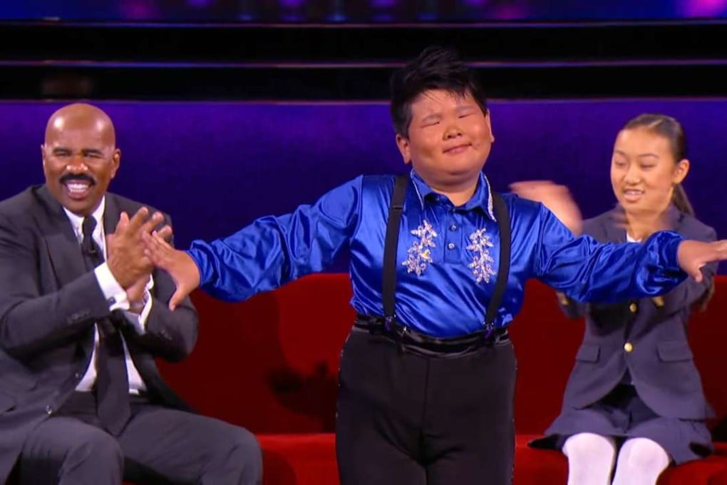 American host Steve Harvey interviews He Xiongfei, centre, with the help of an interpreter on the Little Big Shots reality talent show for children. Photo: Handout