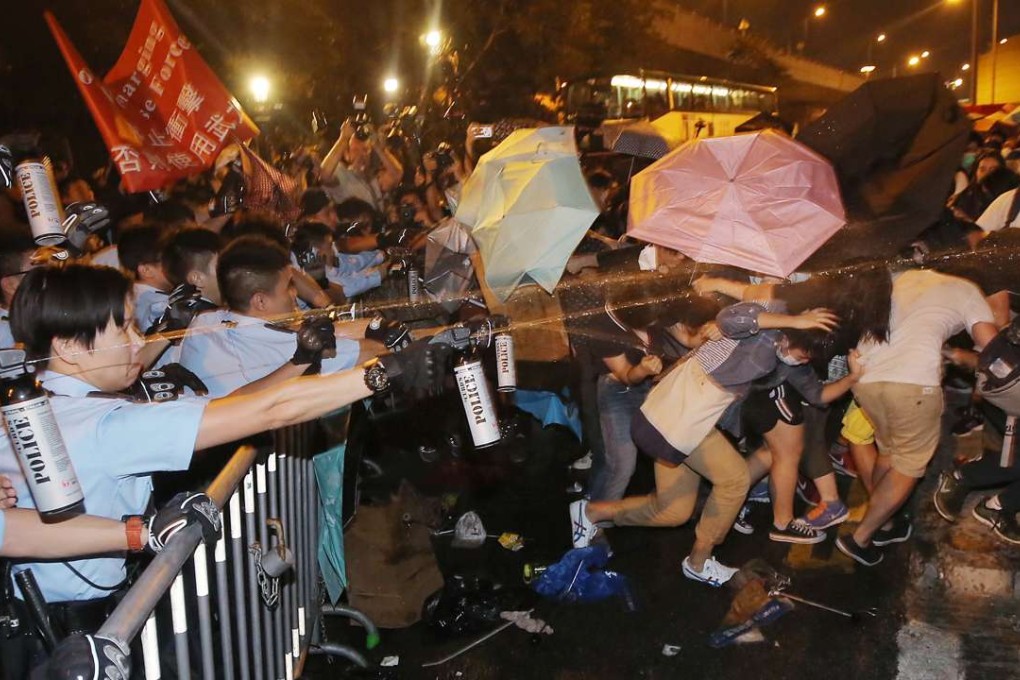 Police pepper spray a crowd of protesters near the Beijing Liason Office in Sai Ying Pun during a rally against National People’s Congress’ interpretation of the Basic Law over Hong Kong legislative oath controversy. Photo: Paul Yeung