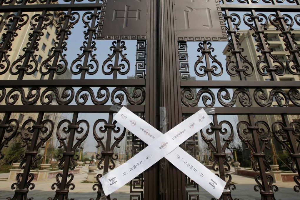 A seal is placed on the gates of a property as the government banned new property sales in counties earmarked as part of a new special economic zone in Xiongxian, Hebei province, China. Photo: Reuters
