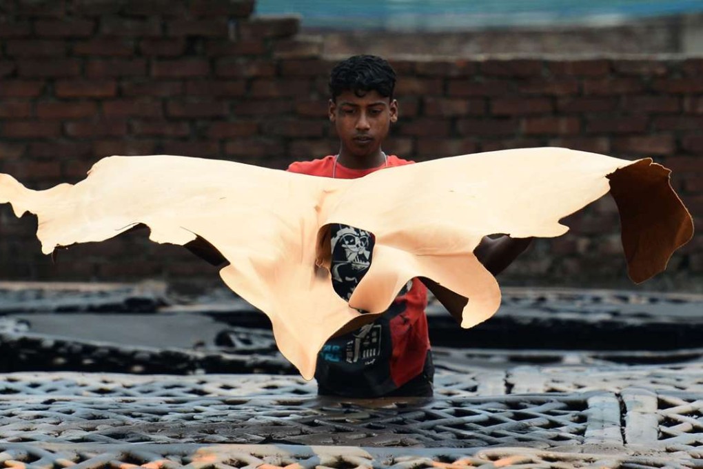 A Bangladeshi worker dries pieces of processed leather at a tannery in Dhaka. Photo: AFP