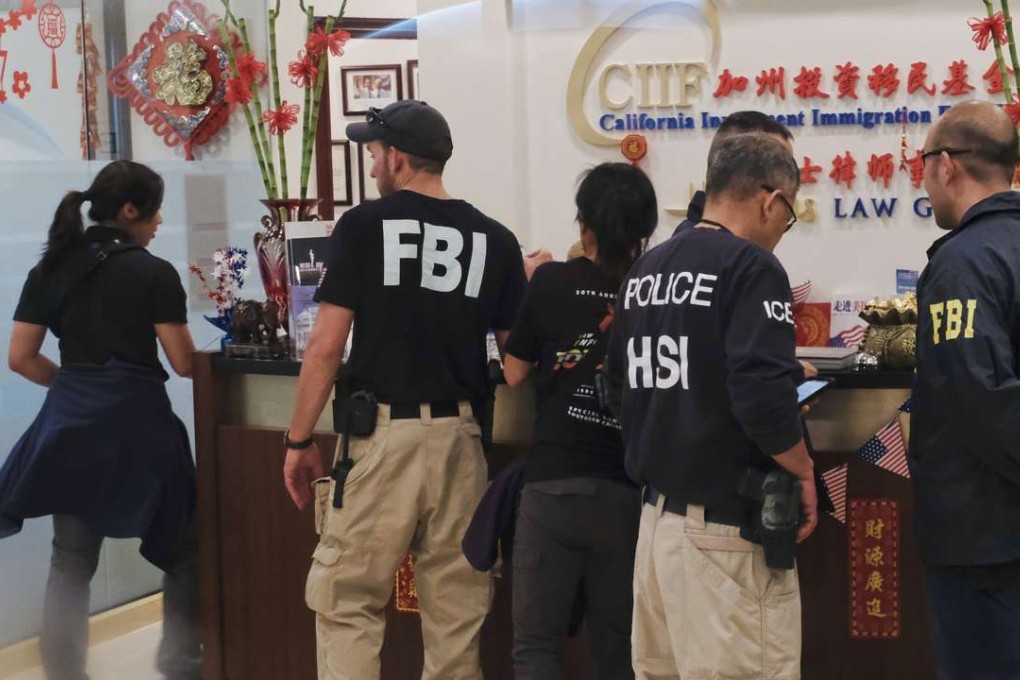 Federal agents work during an investigation inside California Investment Immigration Fund in San Gabriel, Calif., Wednesday, April 5, 2017. Federal authorities on Wednesday raided the Los Angeles-area business they say cheated a US government visa programme to obtain green cards for wealthy Chinese investors, including some who were wanted by the authorities in Beijing. Photo: AP