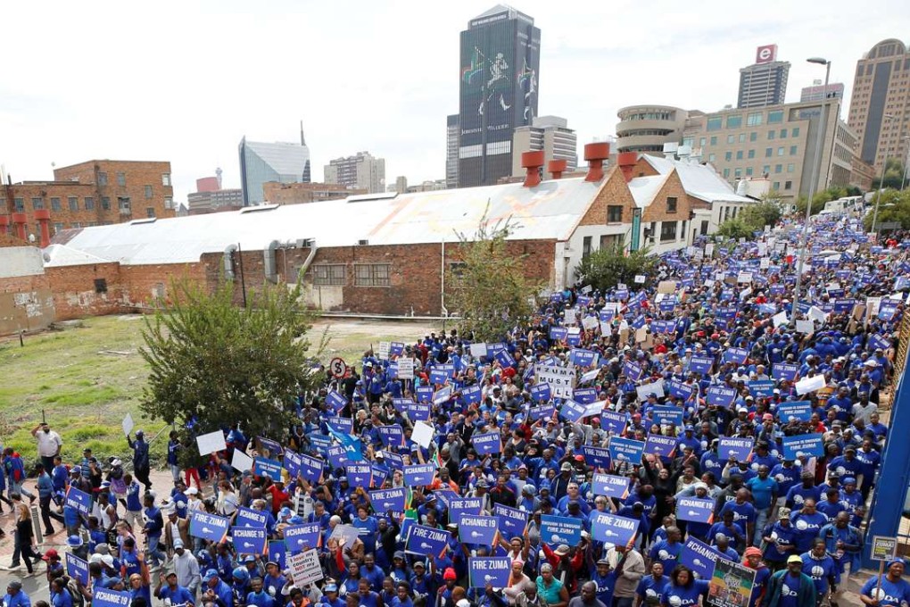 Demonstrators carry banners as they take part in a protest calling for the removal of South Africa's President Jacob Zuma in Johannesburg. Reuters