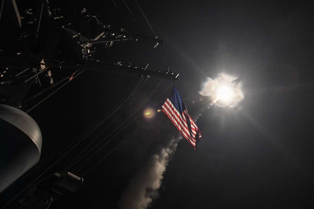 A Tomahawk cruise missile streaks away from the guided-missile destroyer USS Porter on Friday, as part of a barrage on a Syrian airbase. Photo: EPA