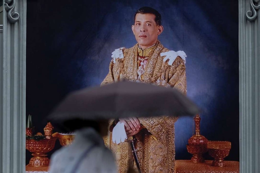 A woman walks past a portrait of Thailand’s King Vajiralongkorn in Bangkok. Photo: Reuters