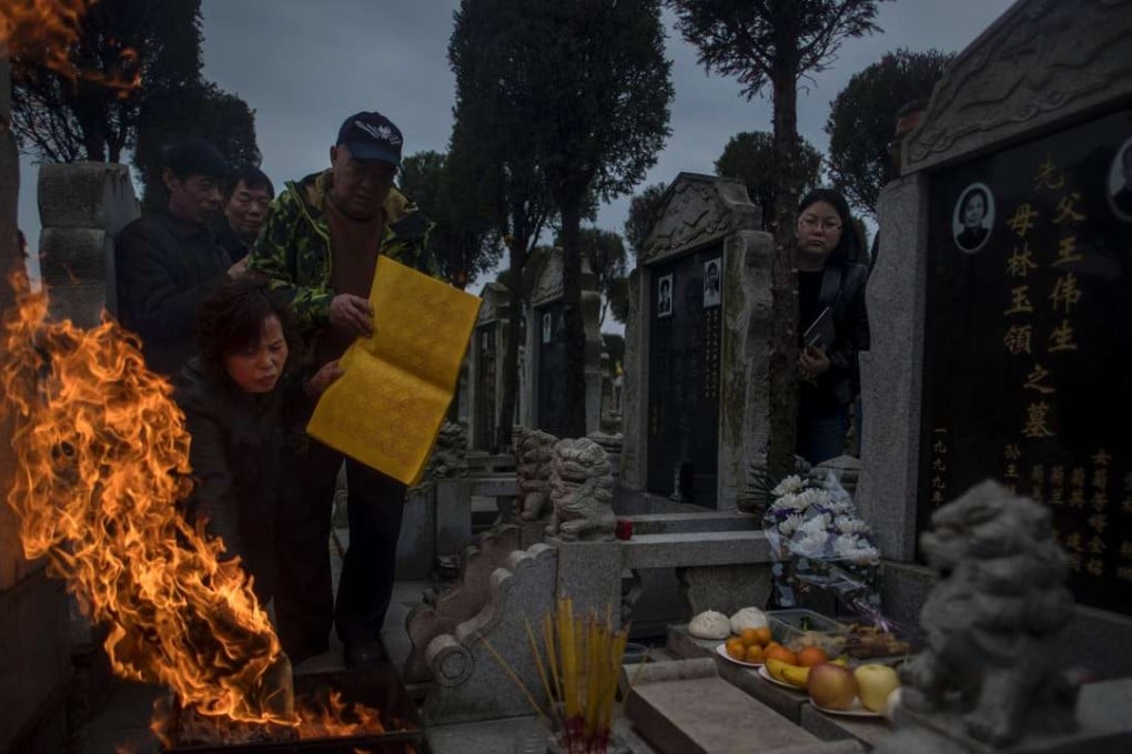 A file picture of a family in Shanghai burning ghost money to pay respects to their ancestors during the grave-sweeping festival. Photo: AFP
