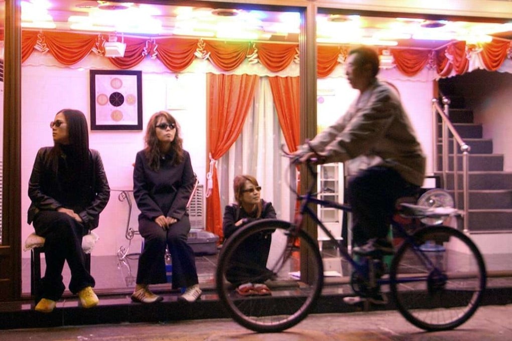 A cyclist rides through a red light district in Seoul. Photo: AFP