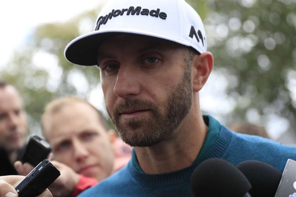 Dustin Johnson of the US speaks with the media outside the clubhouse after withdrawing from the Masters due to injury just as he reached his tee time for the first round of the tournament at the Augusta National Golf Club in Augusta, Georgia. Photo: EPA