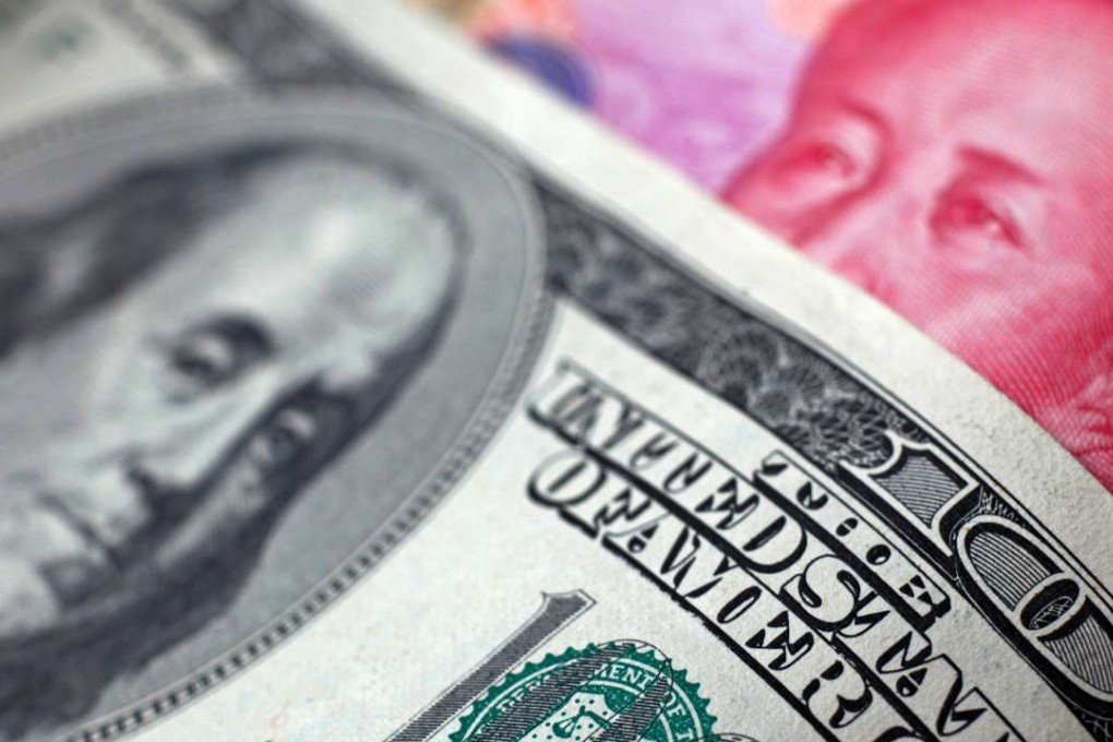 A Chinese 100 yuan banknote is placed under a US$100 banknote as the foreign exchange market turns a cautious eye on the summit meeting between Presidents Donald Trump and Xi Jinping. Photo: Reuters