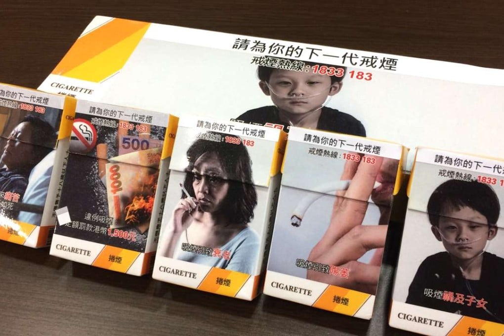 Dummy cigarette packages with health warning graphics covering up to 85 per cent of the surface are displayed at a Council on Smoking and Health press conference on January 16. Photo: Elizabeth Cheung
