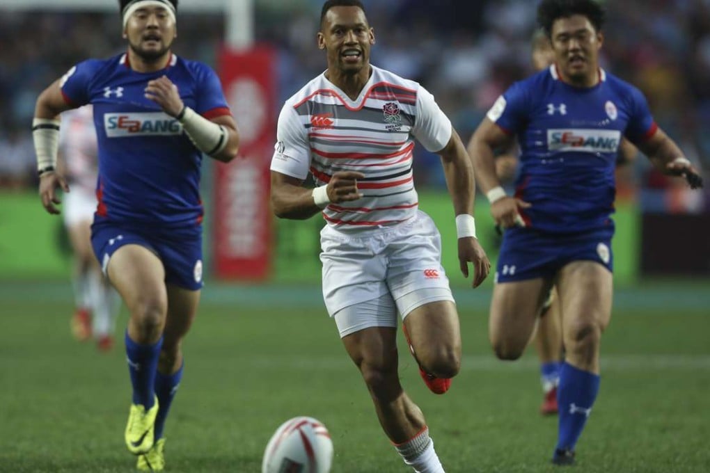 Dan Norton (centre) of England chases the ball during the record-setting win over South Korea. Photo: Jonathan Wong