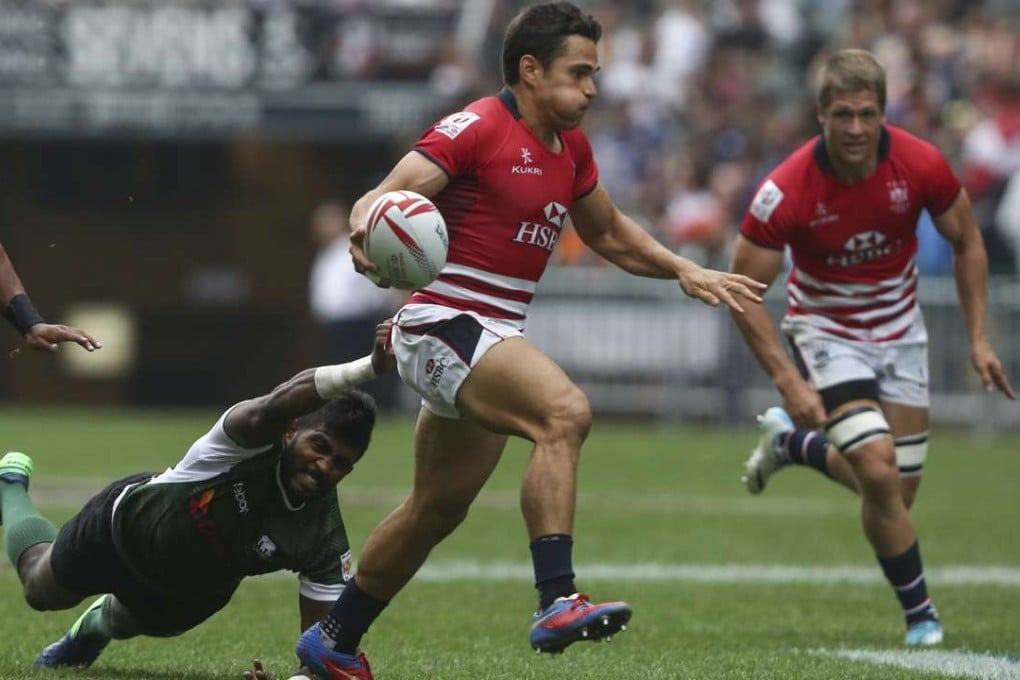 Hong Kong’s Rowan Varty has Lee Jones in support as he evades Dansha Dayan of Sri Lanka on day one of the Cathay Pacific/HSBC Hong Kong Sevens. Photo: Jonathan Wong